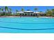 A large community swimming pool with lounge chairs offers relaxation and social opportunities for residents at 850 Tidewater Shores Loop # 108, Bradenton, FL 34208