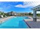 Community swimming pool with cabanas and lounge chairs for residents' enjoyment at 850 Tidewater Shores Loop # 108, Bradenton, FL 34208