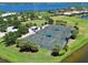 Aerial view of well-maintained tennis courts surrounded by lush landscaping at 850 Tidewater Shores Loop # 108, Bradenton, FL 34208