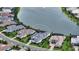Aerial view of a single-Gathering home with an enclosed pool that is situated on a lake at 8537 Pavia Way, Bradenton, FL 34202