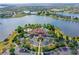 Stunning aerial view of the community clubhouse, pool, and scenic lake at 8537 Pavia Way, Bradenton, FL 34202