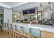 Upscale bar area featuring ample seating, flat screen TVs, and a wide selection of drinks at 8537 Pavia Way, Bradenton, FL 34202