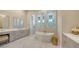 The spa-like bathroom offers a soaking tub, dual vanities, and walk-in shower at 8537 Pavia Way, Bradenton, FL 34202