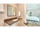 Bathroom featuring modern vanity and mirror alongside a walk-in shower, seamlessly connecting to the bedroom at 8537 Pavia Way, Bradenton, FL 34202