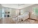 Cozy bedroom with light wood floors, ensuite bathroom with a glass shower, and large windows at 8537 Pavia Way, Bradenton, FL 34202