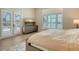 Bright bedroom with access to the pool, showcasing plantation shutters and modern flooring for a stylish retreat at 8537 Pavia Way, Bradenton, FL 34202