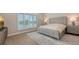 Bright bedroom with plantation shutters, light hardwood floors and a neutral color palette at 8537 Pavia Way, Bradenton, FL 34202