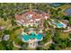 Aerial view of community clubhouse with pools, tennis courts, and lush landscaping at 8537 Pavia Way, Bradenton, FL 34202