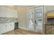 Dining area featuring white cabinetry, quartz countertops, and a beverage refrigerator at 8537 Pavia Way, Bradenton, FL 34202