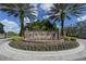 Community entrance featuring a stone waterfall and lush landscaping at 8537 Pavia Way, Bradenton, FL 34202