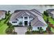 Beautifully landscaped home featuring a grand entrance, modern roof, and a lake view at 8537 Pavia Way, Bradenton, FL 34202