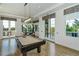 Community game room with billiard table, doors to the outside and ample lighting at 8537 Pavia Way, Bradenton, FL 34202