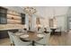 Open-concept kitchen and dining area with wood floors, modern cabinetry and stainless steel appliances at 8537 Pavia Way, Bradenton, FL 34202