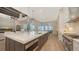 Contemporary kitchen with white cabinets, stainless appliances and view to the living area at 8537 Pavia Way, Bradenton, FL 34202