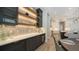 The kitchen features custom cabinets, quartz countertops, open shelves, and a wine refrigerator at 8537 Pavia Way, Bradenton, FL 34202