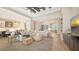 Open-concept living room and kitchen featuring light wood floors and neutral decor at 8537 Pavia Way, Bradenton, FL 34202