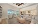 Spacious open-concept living room with a modern ceiling fan and access to the outdoor patio at 8537 Pavia Way, Bradenton, FL 34202