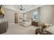 Bright and spacious main bedroom featuring neutral colors, tray ceiling, and large windows at 8537 Pavia Way, Bradenton, FL 34202