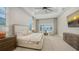 Spacious main bedroom with tray ceilings, pool view, and large windows. Neutral color palette at 8537 Pavia Way, Bradenton, FL 34202