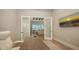 Home office boasts natural light, hardwood floors, and glass doors leading to another room at 8537 Pavia Way, Bradenton, FL 34202