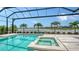Beautiful pool and spa area overlooking a lake and lush landscaping at 8537 Pavia Way, Bradenton, FL 34202