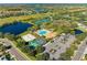 Community aerial view showcasing amenities including pool, tennis, volleyball, and lakes surrounded by lush landscaping at 8772 Stone Harbour Loop, Bradenton, FL 34212