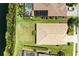 A bird's eye view of the home's tile roof, green lawn, and proximity to a body of water at 8772 Stone Harbour Loop, Bradenton, FL 34212