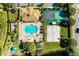 Aerial view of community pool, sports courts, and clubhouse surrounded by manicured landscaping at 8772 Stone Harbour Loop, Bradenton, FL 34212