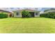 Well-maintained backyard featuring lush lawn, mature landscaping, and a private patio for outdoor enjoyment at 8772 Stone Harbour Loop, Bradenton, FL 34212