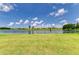 Scenic backyard with lake view offers a serene landscape, perfect for relaxation and outdoor activities at 8772 Stone Harbour Loop, Bradenton, FL 34212