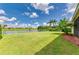 Expansive backyard featuring lush green lawn and scenic lake views, ideal for outdoor enjoyment at 8772 Stone Harbour Loop, Bradenton, FL 34212