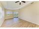 Bright bedroom with tray ceiling, ceiling fan, wood-look tile flooring, and a window at 8772 Stone Harbour Loop, Bradenton, FL 34212