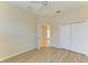 Light bedroom featuring wood-look floors, ceiling fan, and closet at 8772 Stone Harbour Loop, Bradenton, FL 34212