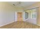 Large bedroom with wood-look floors leading to a screened-in patio at 8772 Stone Harbour Loop, Bradenton, FL 34212