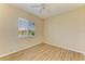 Bedroom with wood-look floors and a view of the lake at 8772 Stone Harbour Loop, Bradenton, FL 34212