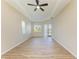 Spacious bedroom with tray ceiling, wood-look tile flooring, and sliding glass door at 8772 Stone Harbour Loop, Bradenton, FL 34212