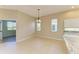 Open dining area featuring tile flooring, neutral walls, and contemporary chandelier at 8772 Stone Harbour Loop, Bradenton, FL 34212