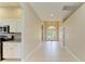 Open foyer with tiled flooring, leading to the front entry and kitchen at 8772 Stone Harbour Loop, Bradenton, FL 34212
