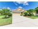 Well-maintained home with a two-car garage, neutral paint, and tropical landscaping at 8772 Stone Harbour Loop, Bradenton, FL 34212