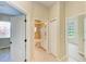 Hallway leads to a bathroom and bedroom with neutral walls at 8772 Stone Harbour Loop, Bradenton, FL 34212