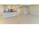 Open-concept kitchen featuring a large center island, white cabinets and stainless steel appliances at 8772 Stone Harbour Loop, Bradenton, FL 34212