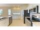 Bright kitchen with stainless steel appliances, granite countertops, and white cabinets at 8772 Stone Harbour Loop, Bradenton, FL 34212