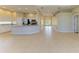 Expansive living space with a combination of kitchen and living area featuring neutral tiling and lots of natural light at 8772 Stone Harbour Loop, Bradenton, FL 34212