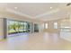 Open-concept living space featuring neutral tile floors, recessed lighting and sliders leading to the outside at 8772 Stone Harbour Loop, Bradenton, FL 34212