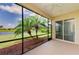 Enjoy the views from this screened-in lanai featuring lovely palm trees and a serene lake at 8772 Stone Harbour Loop, Bradenton, FL 34212