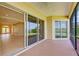 Inviting screened-in lanai with tiled flooring and sliding glass doors boasts picturesque water views, perfect for relaxing at 8772 Stone Harbour Loop, Bradenton, FL 34212