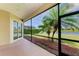 Relaxing screened-in patio with beautiful views of the lush landscaping and peaceful lake at 8772 Stone Harbour Loop, Bradenton, FL 34212