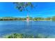 Picturesque view of the tranquil community pond with a charming lighthouse in the center at 8772 Stone Harbour Loop, Bradenton, FL 34212