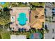 Aerial view of the community swimming pool with many lounge chairs and a splash fountain at 8772 Stone Harbour Loop, Bradenton, FL 34212