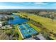 Aerial view of the community tennis courts and lake at 8772 Stone Harbour Loop, Bradenton, FL 34212